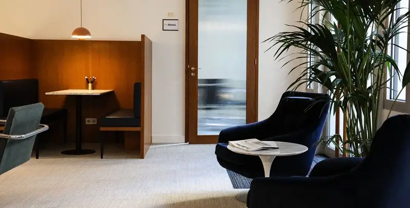 Virtual office rental Paris France - The Bureau elegant exclusive coworking space with wooden private booths, warm lighting and club atmosphere
